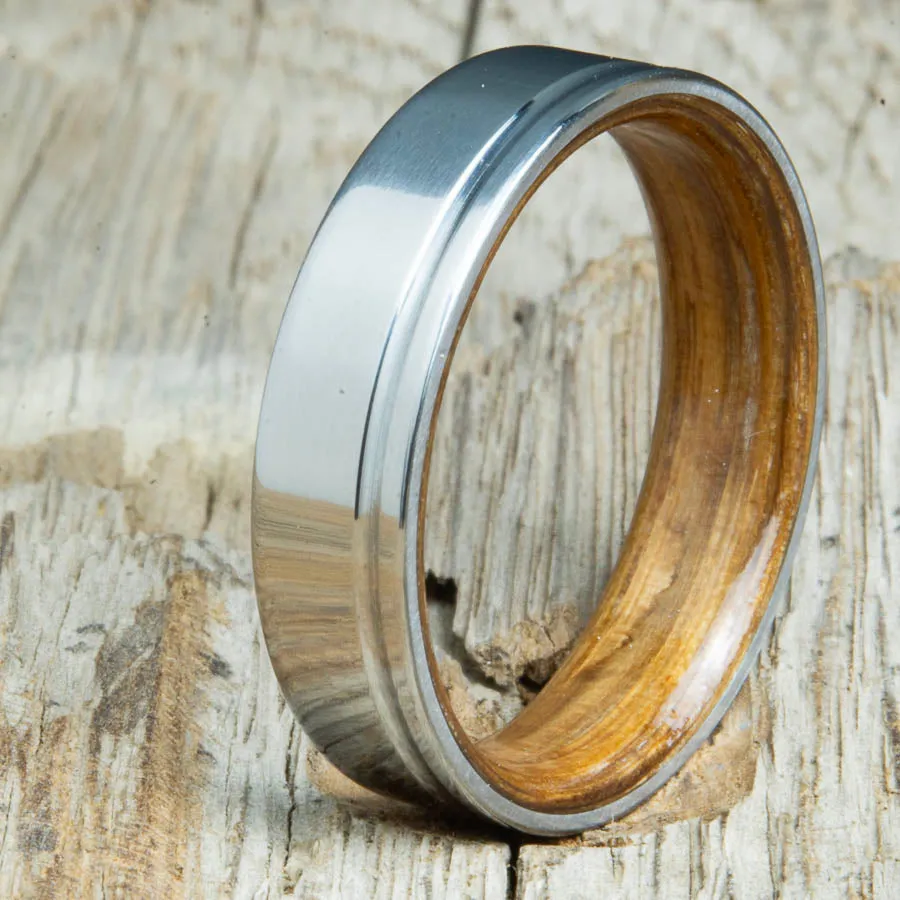 Polished titanium wedding band with Whiskey barrel interior
